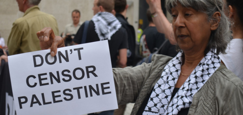 Protester holding up sign saying "Don't censor Palestine"