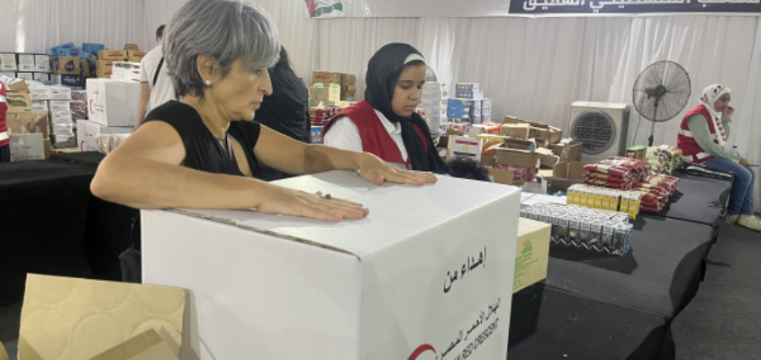 Palestinian writer Susan Abulhawa packing boxes of aid for Gaza at the Egyptian Red Crescent.