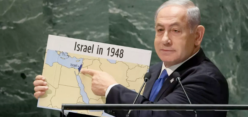 Netanyahu holding up a map of the Middle East with occupied Palestine marked as "Israel"
