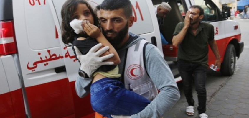A child is carried from an ambulance after a bombing