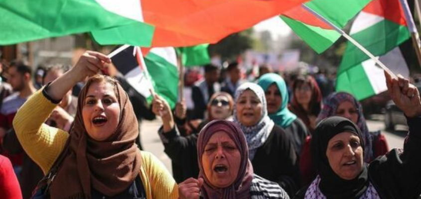 Palestinian women marching in a protest