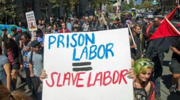 Protest sign saying "prison labor = slave labor"