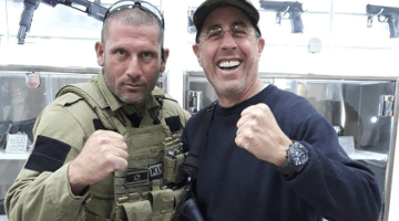 Armed Jerry Seinfeld, who favors gun control at home, poses with Israeli tour guide.