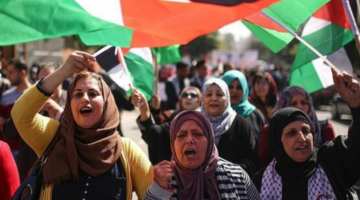 Palestinian women marching in a protest