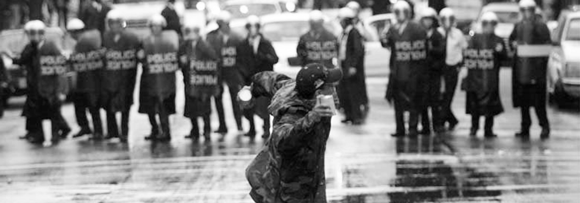 Protester throwing a rock at the police