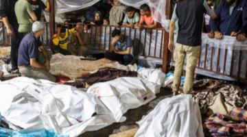 The bodies of the dead in a bombing on al-Ahli Hospital are gathered outside another hospital in Gaza