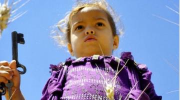 Child holds key to her home in Palestine