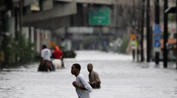 New Orleans residents walk through chest deep floodwater during Hurricane Katrina