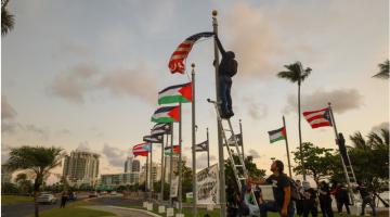 Protesters take down US flag