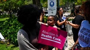 Child holding a sign abortion rights rally